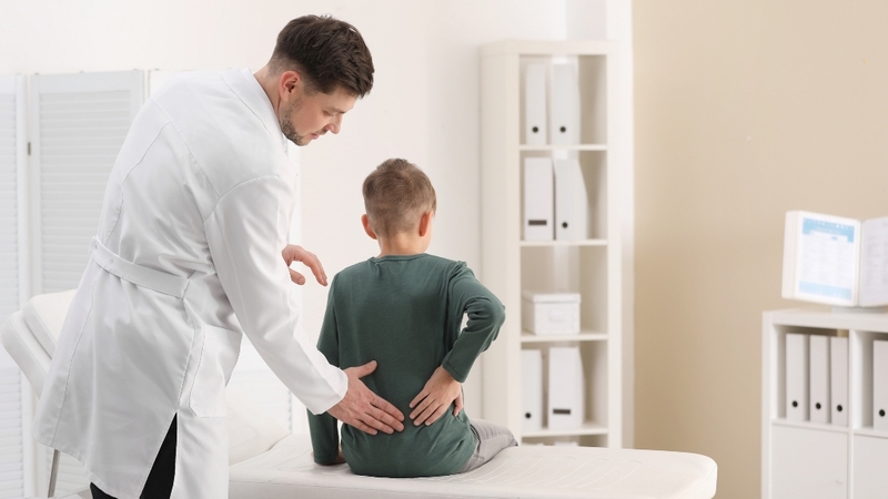 Trẻ đau mỏi lưng kéo dài có thể liên quan đến cong vẹo cột sống học đường