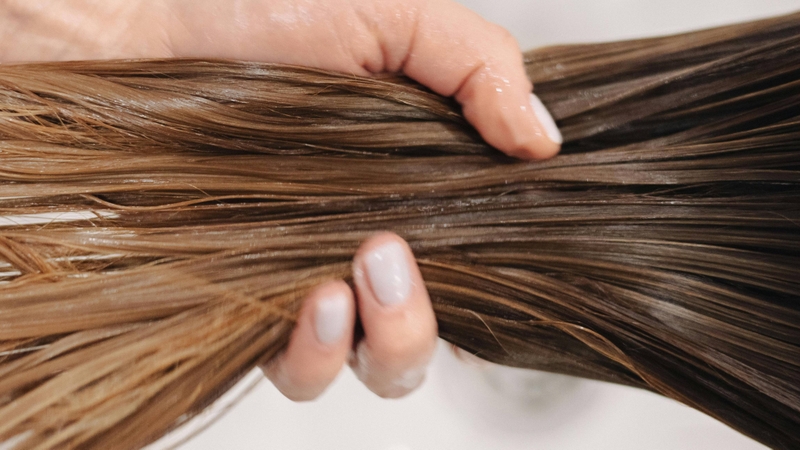 Bạn lấy một lượng dầu xả vừa đủ rồi thoa đều từ phần thân đến ngọn tóc